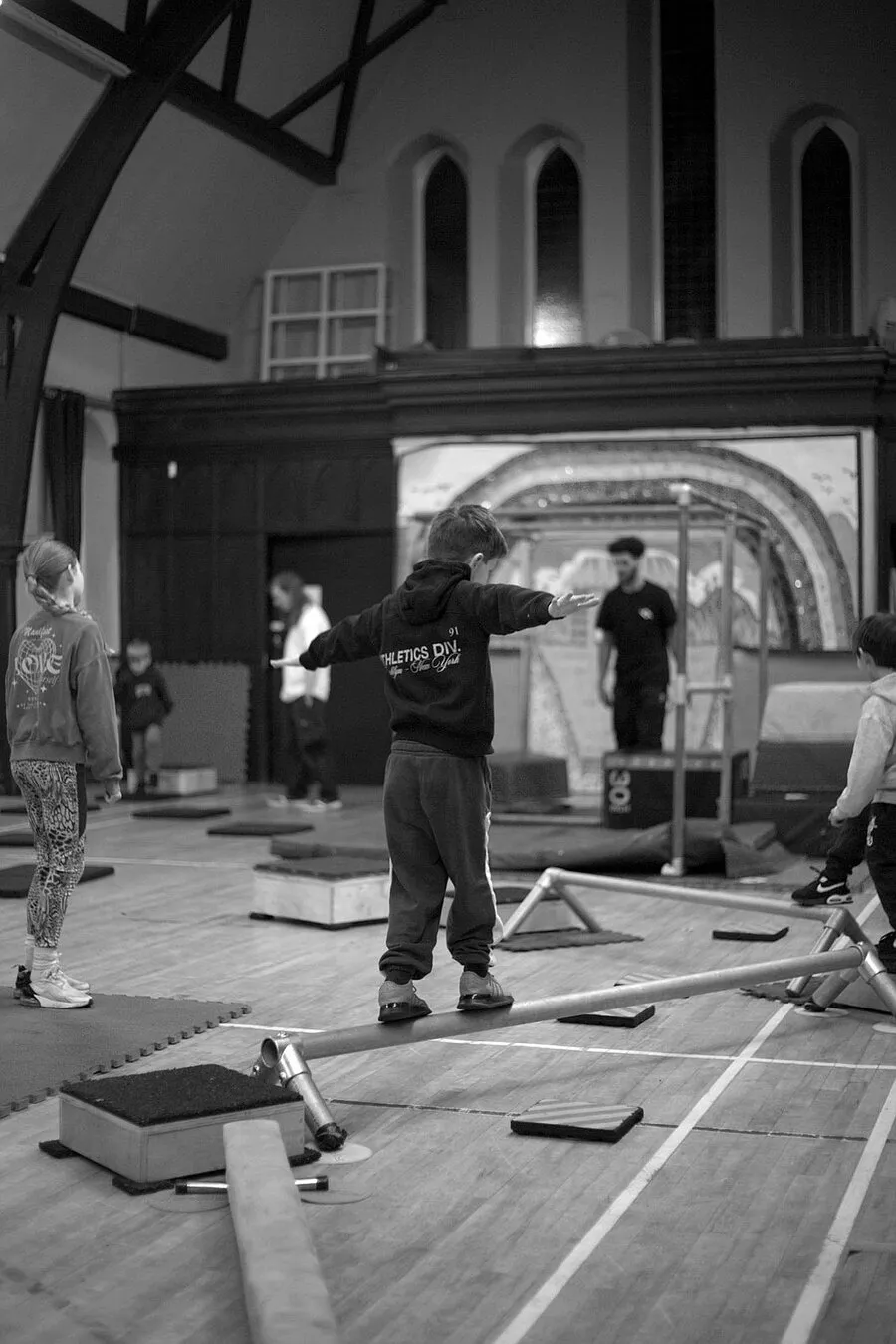Young person practicing balance on a beam during a Movement Matters Parkour session