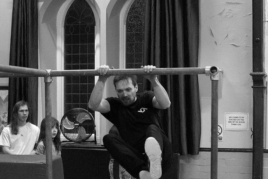Coach demonstrating parkour movement during a community session at Hope Church Hoylake