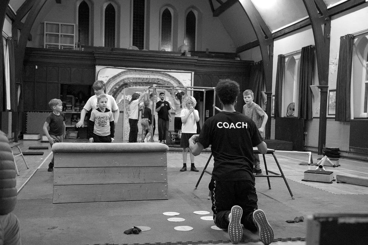 Movement Matters coach leading a group warm up session with young people